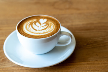 A cup of coffee on old wooden table in cafe coffee break in morning