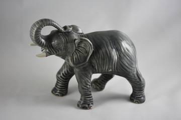 Fototapeta na wymiar gray porcelain elephant on a black background