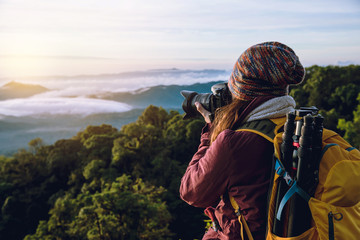 The young woman travels to take pictures of the sea mist on the mountain. Travel relax. Natural Touch countryside. at Chiangmai inThailand