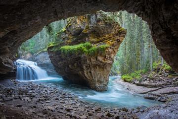 Johnston Canyon cave in Spring season with waterfalls, Johnston Canyon Trail, Alberta, Canada - 243968523