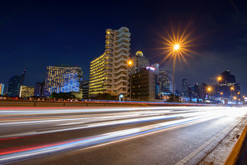 Fototapeta na wymiar blur light of car traffic and sky train in city