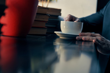 hands a cup of coffee