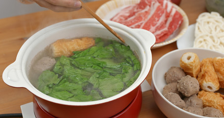 Family enjoy hot pot dinner together