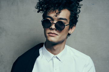 Obraz premium stylish man with curls in glasses portrait