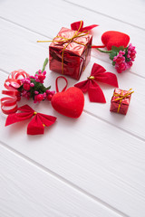 Conceptual still life for Valentine's Day on a wooden white background with space for text