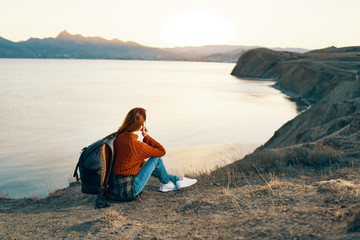 woman sitting watching the sea sunset trip