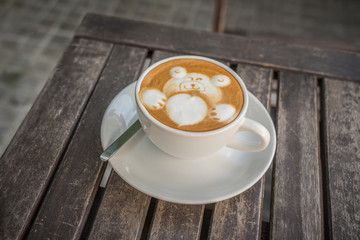 cup of coffee with Valentine bear latte art on top