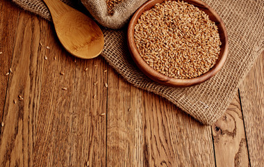 brown rice in wooden spoon