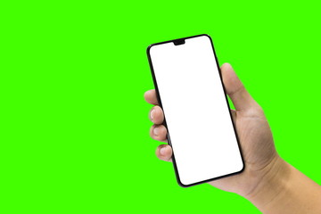 Man holding a black mobile phone and blank screen isolated on a green background.