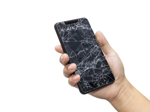 Man holding a black mobile phone and screen broken isolated on a white background.
