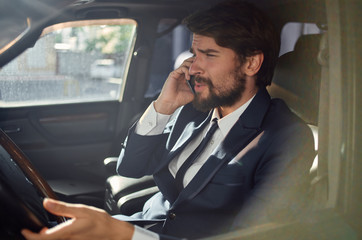 business man talking on the phone driving a car