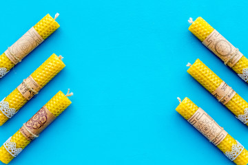 Buddhism. Candles with Yantras and mantras in sanskrit on blue background top view pattern copy space