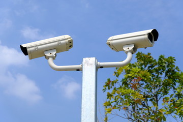 Closed-circuit camera or CCTV on the sky background.
