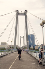 People walk on a pedestrian bridge.