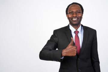 Portrait of happy African businessman giving thumbs up
