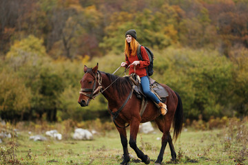 woman riding a horse in the mountains