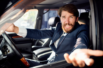 Fototapeta na wymiar business man with a beard riding a car talking