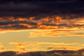 Naklejka na ściany i meble Dramatic sunrise golden orange color clouds