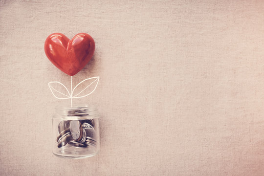 A Jar Of Heart Tree Growing On Money Coins, Social Responsibility And Donation Concept