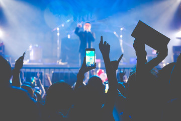 Crowd at concert, people use smart phones record video at music concert