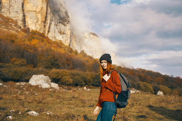 woman in the mountains with a backpack nature travel autumn