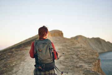 woman in the mountains with a backpack nature travel autumn