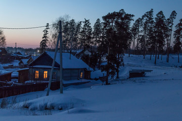 evening village in a pine forest