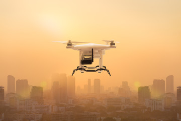 Fototapeta na wymiar Drone flying to measure dust particles in the air over metropolis, Technology 4.0 concept