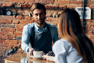 bartender with a cup of coffee cafe woman