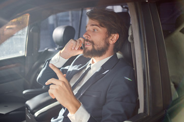 business man talking on the phone sitting in the car