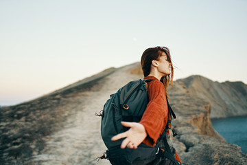 Fototapeta premium young woman with backpack hiking in nature