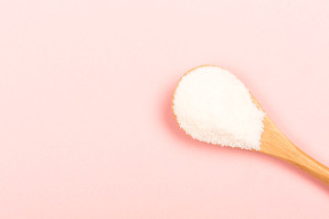 Collagen powder on pink background
