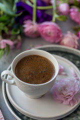 Cup of coffee and flowers