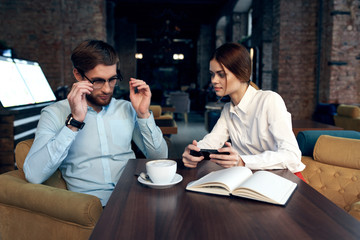 business people in a cafe communicate documents coffee