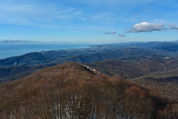 Panorama of the Sochi city from high mountain. Landscape. Blue sea and hills.