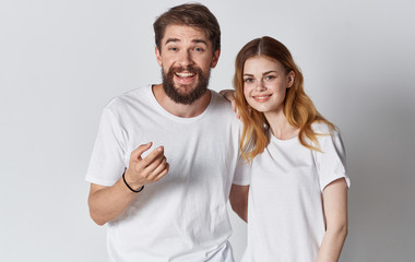 Fototapeta premium young couple in white t-shirts logo place free emotions