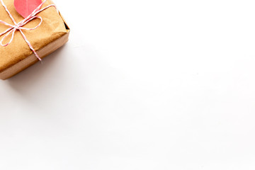 Wrapped vintage gift box in the corner with pink ribbon bow on white background