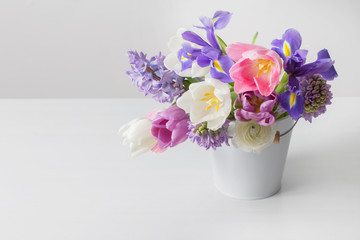 Naklejka na ściany i meble spring flowers in bucket on white background