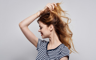 woman smiling holding hair with her hands