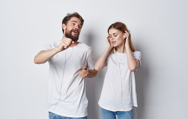 young couple listening to music on headphones