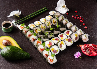 Rainbow Sushi set with salmon, eel, tuna, avocado, royal prawn, cream cheese Philadelphia, caviar tobica, chuka. Sushi menu. Japanese food