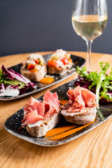 Sandwich with prosciutto, cheese and lettuce