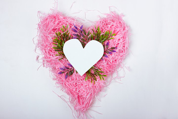 Paper white heart on pink paper on white background. Space for text