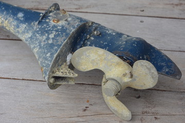 Lower leg part of weathered outboard engine with propeller and other metal surfaces covered with remains of barnacles and other encrusting sea life forms. © Daniel Poloha