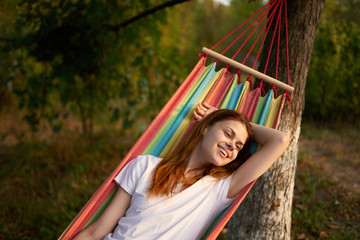 woman resting in nature lying on a hammock village summer