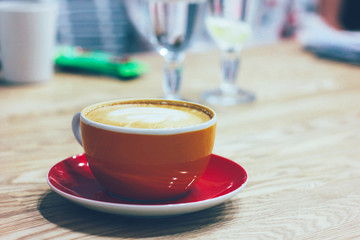 The cup with coffee on table. Everyday working morning routine in office