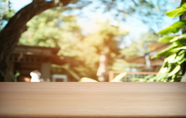 Empty dark wooden table in front of abstract blurred bokeh background of restaurant . can be used for display or montage your products.Mock up for space.