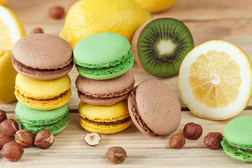 Green, yellow and brown french macarons with lemon, kiwi and hazelnuts