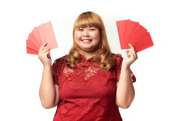 Asian woman holding ang pow or red packet monetary gift. Chinese new year concept.