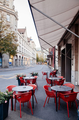 Street cafe with modern red chairs in Zurich Old town Altstadt